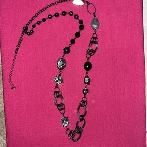 Lang black necklace with multi charms.